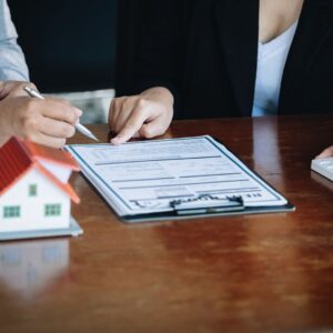 Client and realtor reading paperwork before signing.